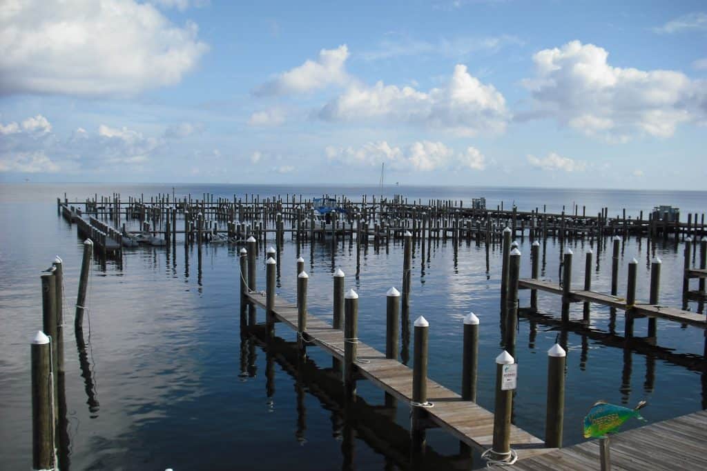 23 Affordable Weekend Getaways in the United States 17 Mobile Bay in Mobile, Alabama with many wooden docks jutting into the water.