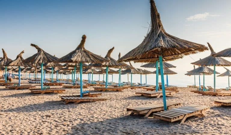 Beach chairs and natural fiber umbrellas at Vama Veche, Romania.